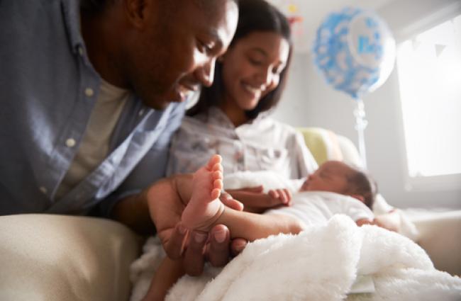 Parents looking at their newborn