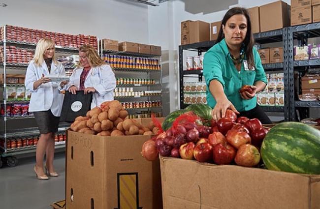 Women shopping produce at food pantry