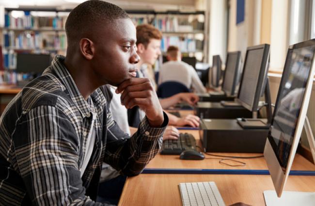 Teen looking at a computer