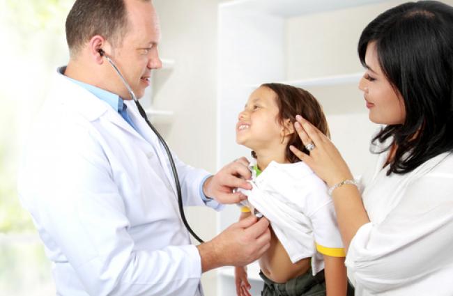 A doctor examining a child