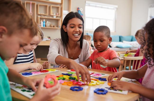 Teacher and pre-schoolers with arts & crafts