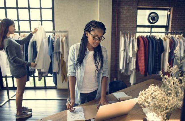 Image of two young women working in clothing store.