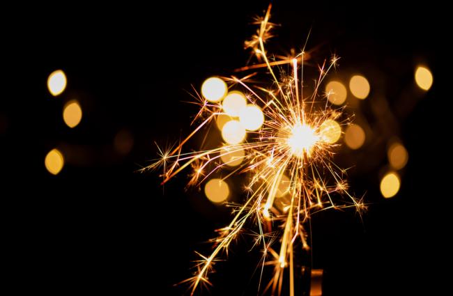 Sparkler firework in front of a dark background