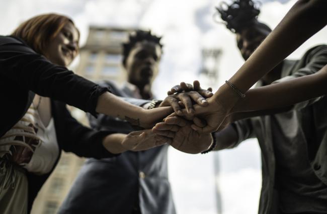 Group of African American women with their hands together like a team