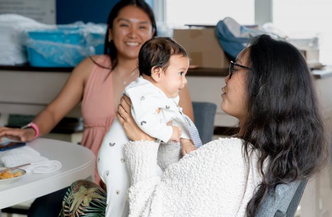 Woman holds her baby