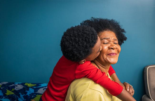 Black child kissing his grandmother