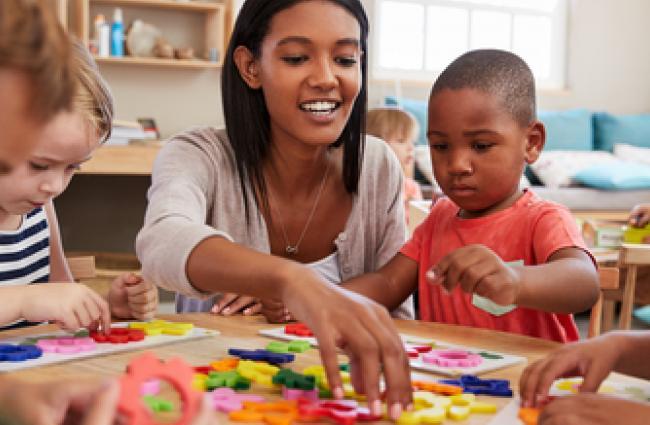 Teacher and pre-schoolers with arts & crafts