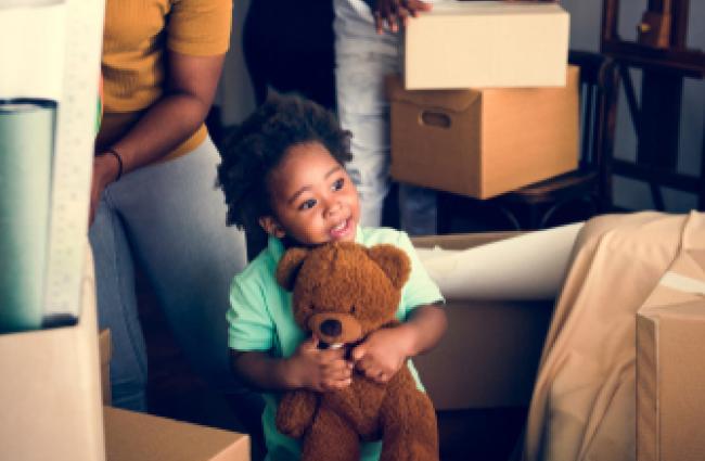 Small child holding teddy bear