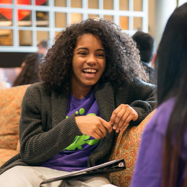 Female students talking on a couch