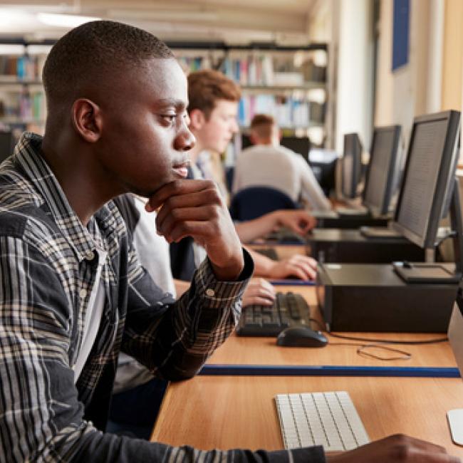 Teen looking at a computer