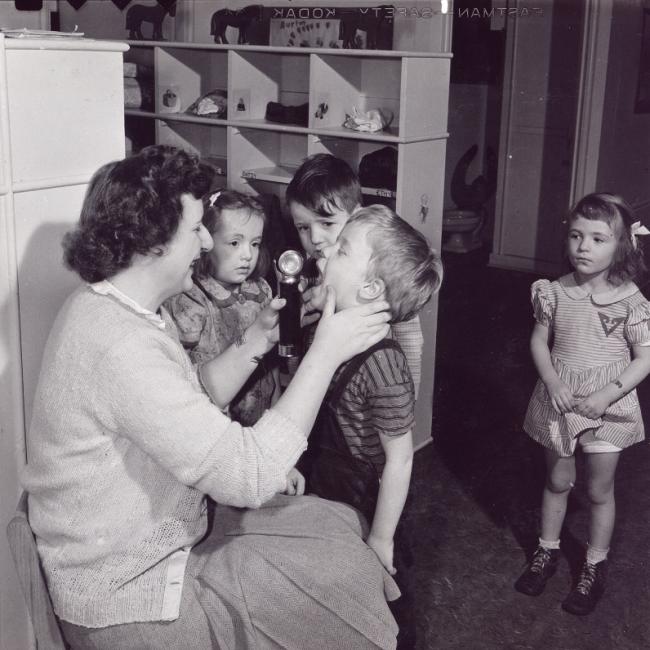 Old image of teacher with students (1940's)