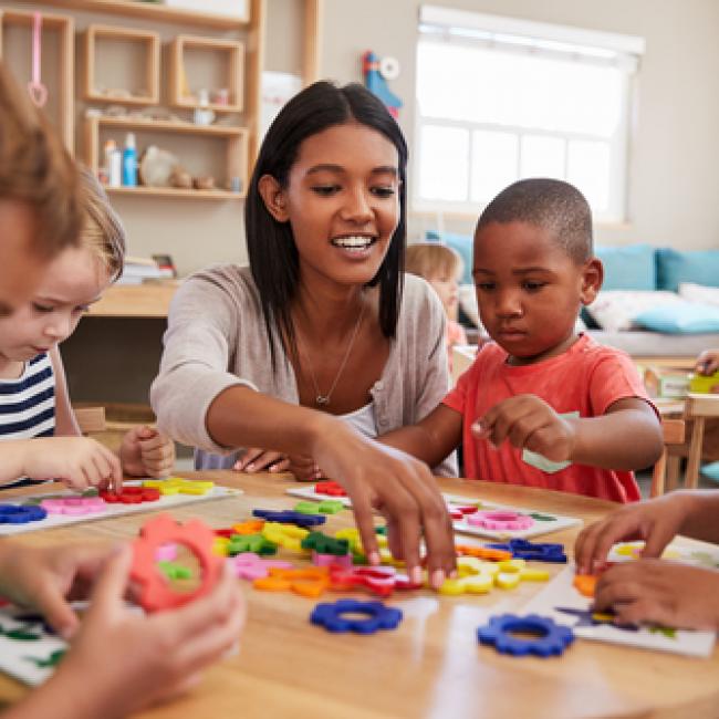 Teacher and pre-schoolers with arts & crafts