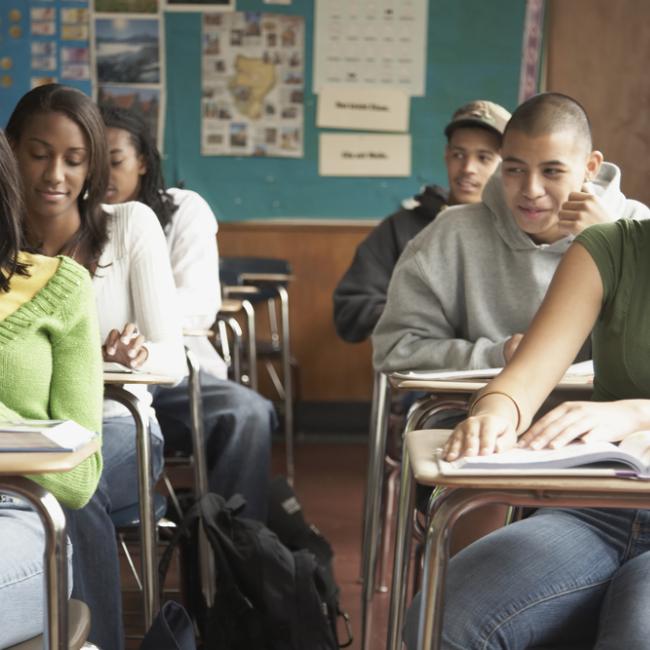 Young teens in class at their desk