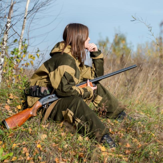 Women with firearm hunting for wild game