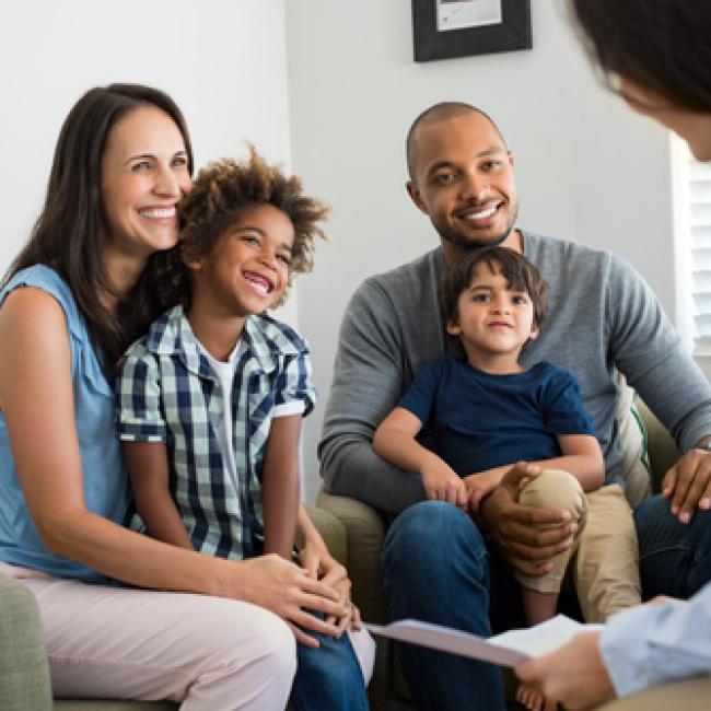 Family sitting together talking with consultant