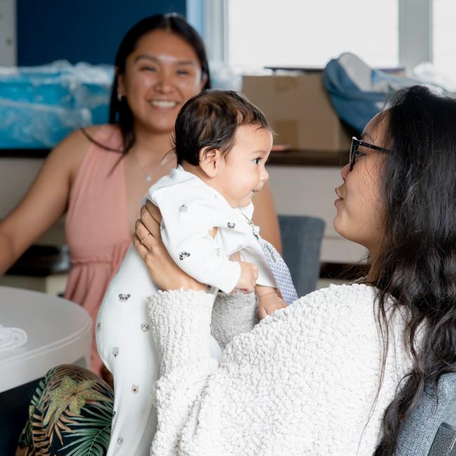 Woman holds her baby