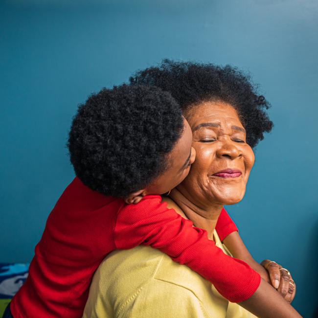 Black child kissing his grandmother