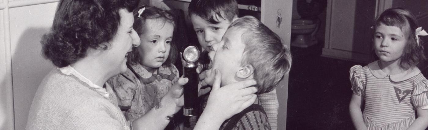 Old image of teacher with students (1940's)