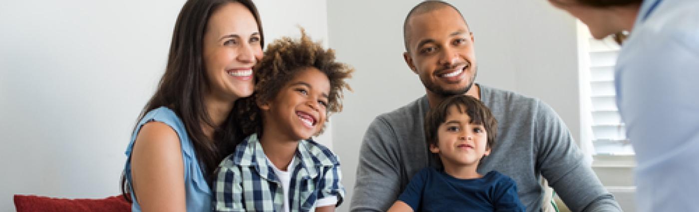 Family sitting together talking with consultant