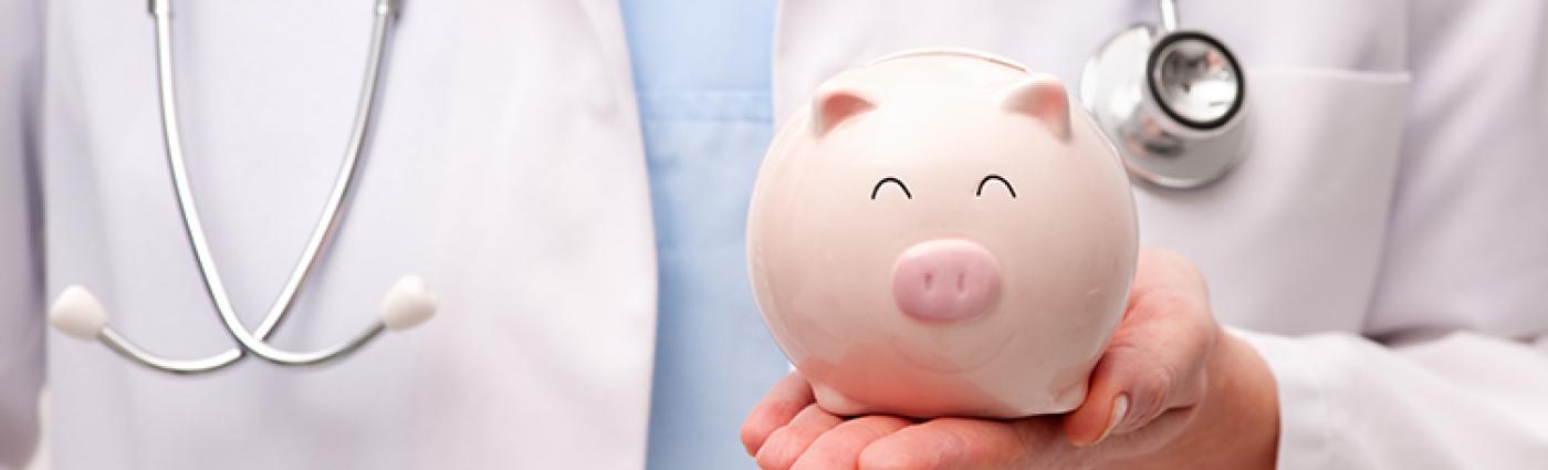 Image of medical professional holding a piggy bank.