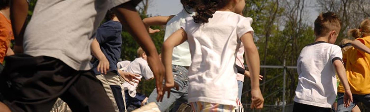 Image of children running through playground.