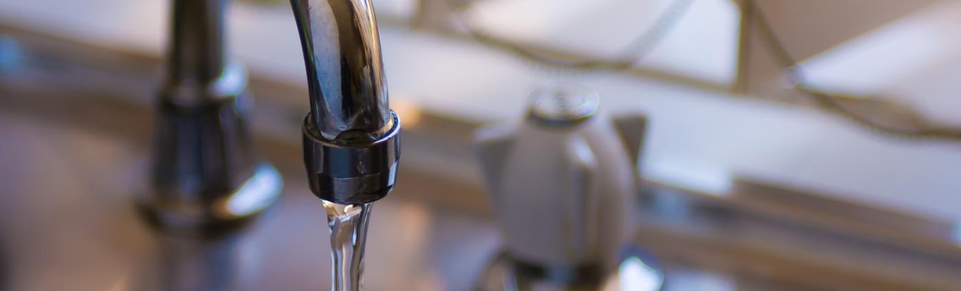 Faucet with running water into a sink