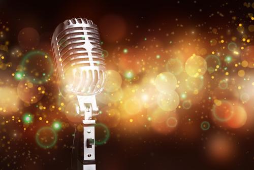 Old-fashioned chrome rectangular microphone with orange and green flashes of light