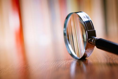 Magnifying glass standing on it's side on a wooden table