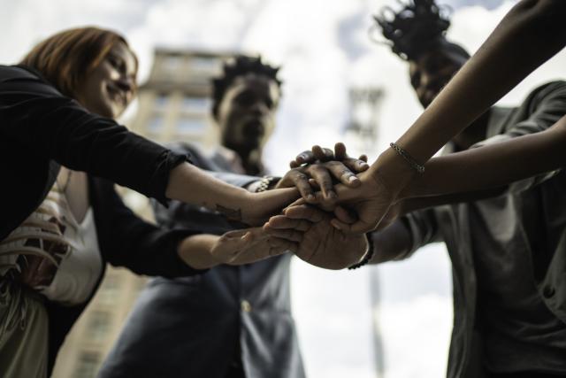 Group of African American women with their hands together like a team