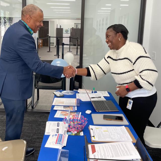Omaha mayor, John Ewing, shakes hands with a BEAT Cancer team member at a Nebraska DMV